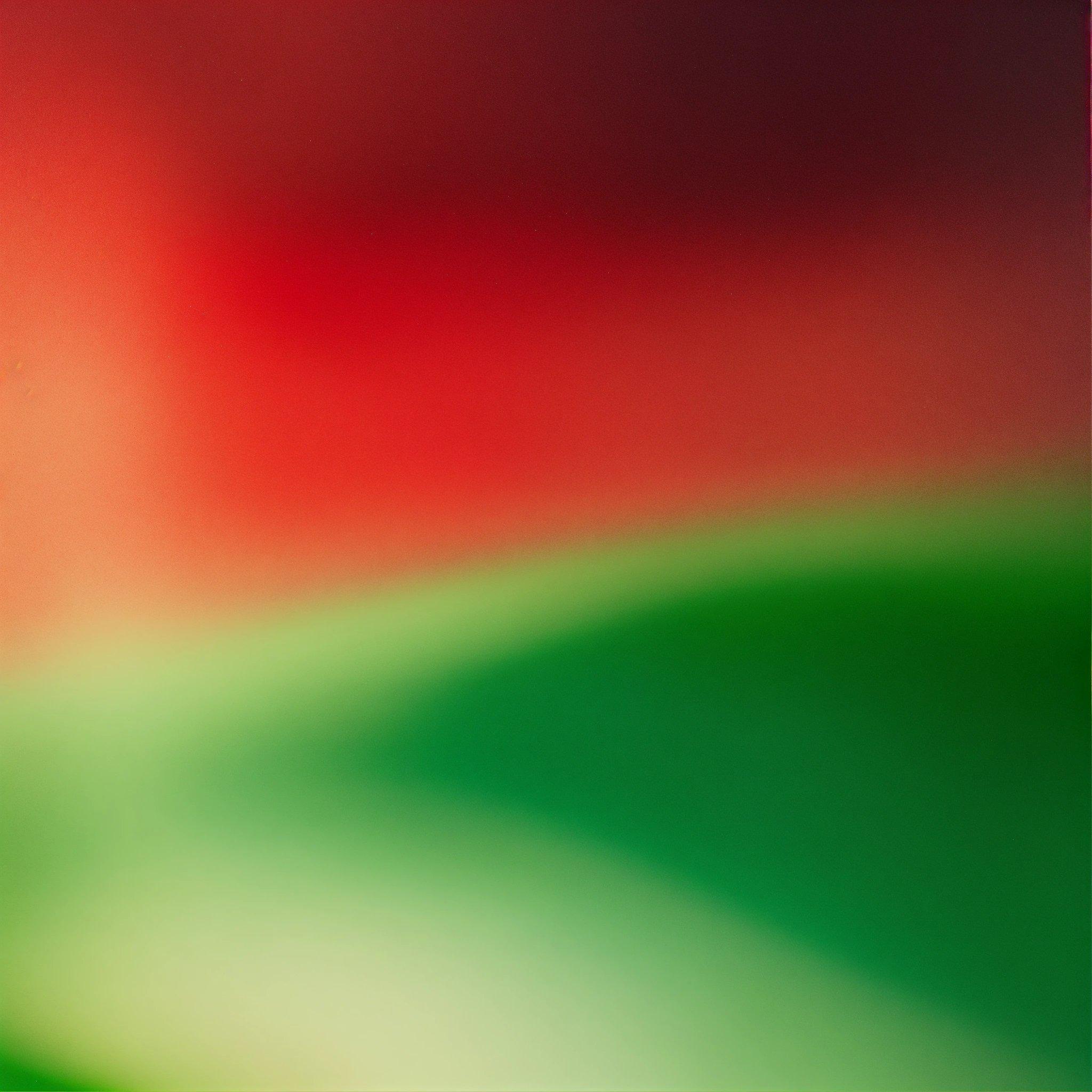 A Blurry Image Of A Red And Green Background