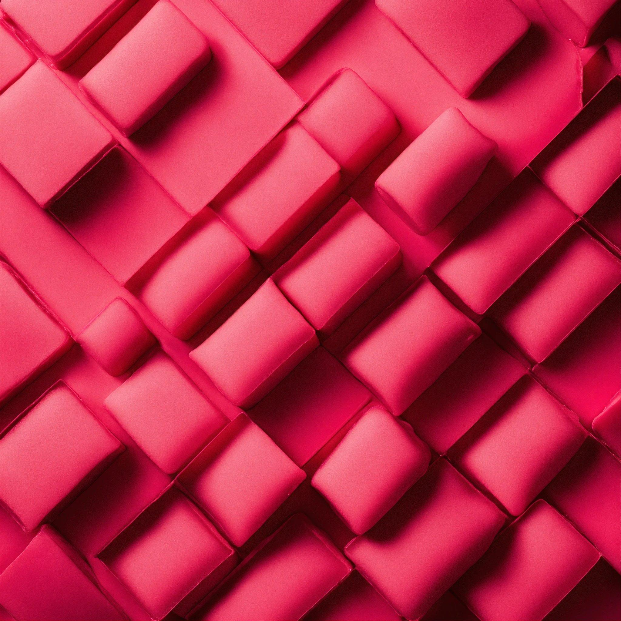 A Close Up Of A Pink Wall Made Of Squares And Rectangles