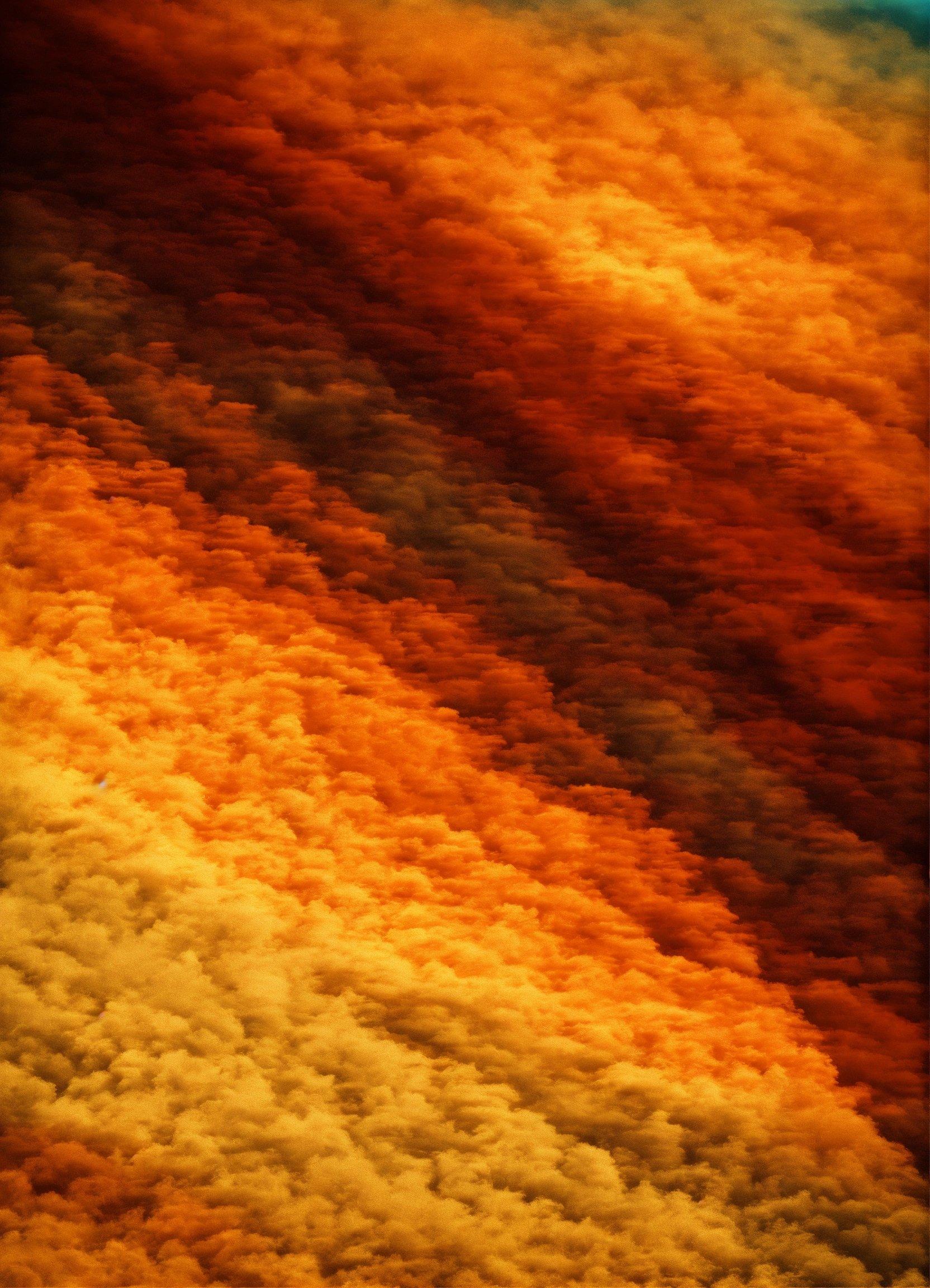 An Orange And Yellow Background With Some Clouds